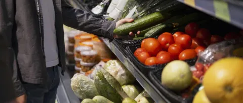A consumer going through veggies section 
