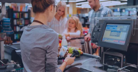 A person sitting at a cash counter
