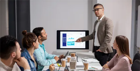 Business project team receiving training on technical and functional aspects of migration during a corporate workshop.