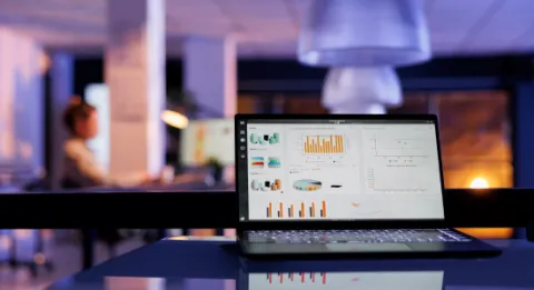 Customer support agent analyzing digital dashboards and customer data, representing predictive analytics for identifying and reducing customer churn
