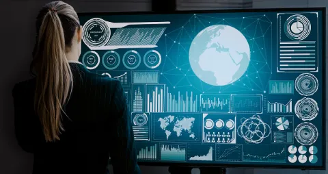 Large Computer screen displaying interactive dashboards and data visualization alongside design tools for collaborative planning